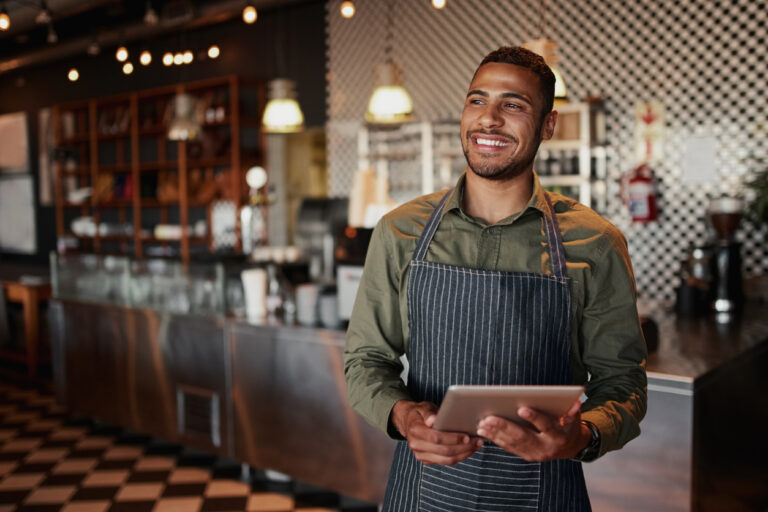 restaurant group purchasing organization. Man in apron with tablet