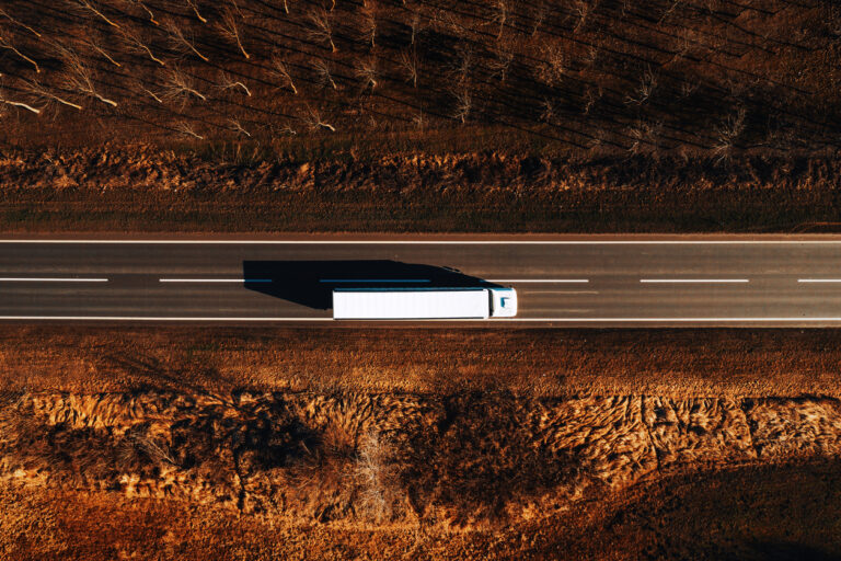 semi truck driving down a fall road