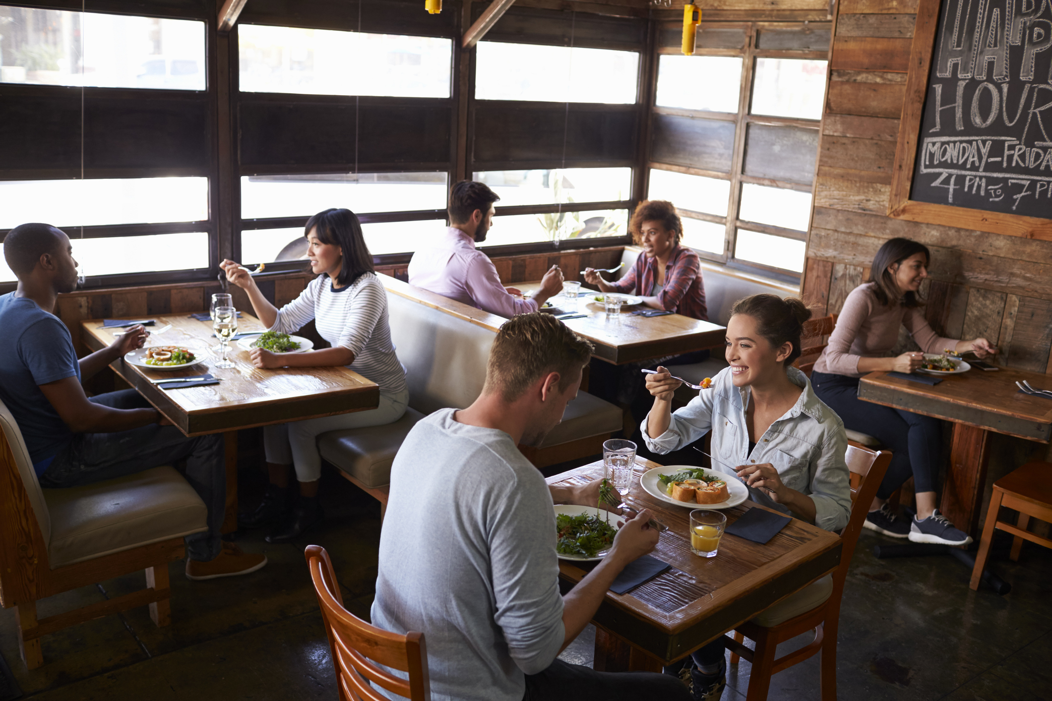 Couples relaxing over lunch in a restaurant, elevated view