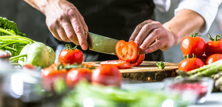 Chef cook preparing vegetables in his kitchen